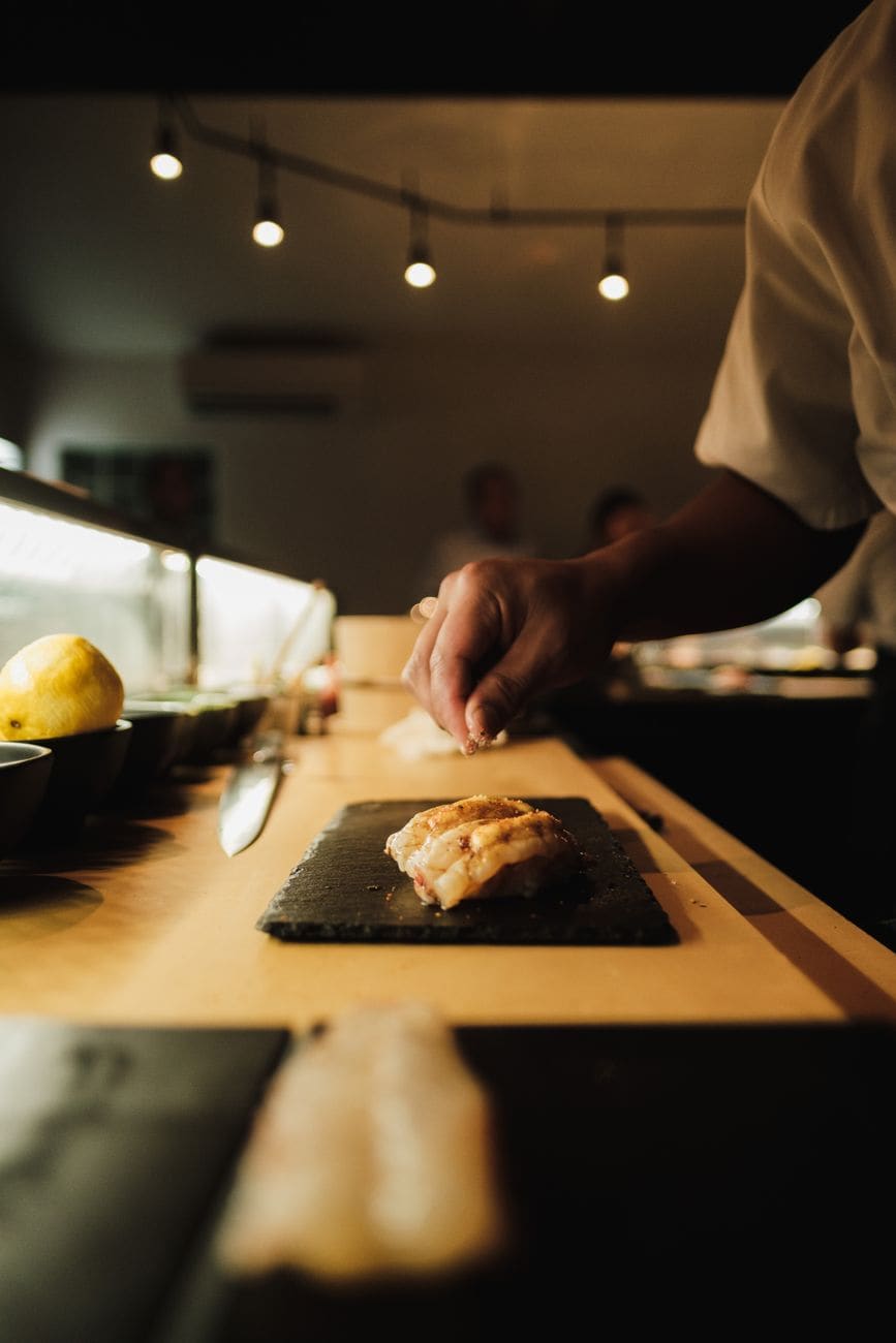 Mistr sushi Sushičko připravuje nigiri u pultu